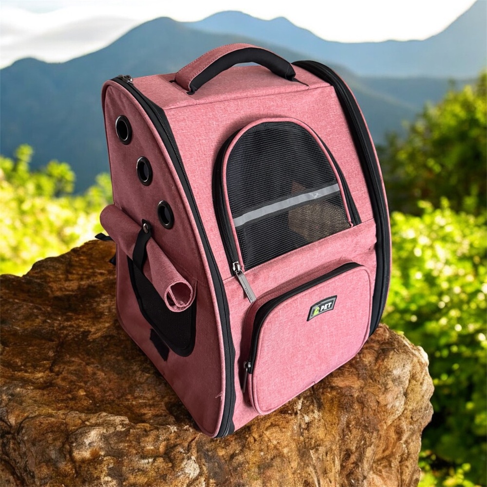 Pet carrier backpack for cats and small dogs with many ventilation holes.